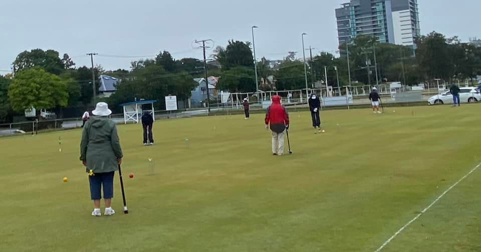 Windsor Golf Croquet Monthly Brooch held in the rain