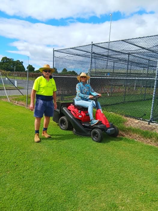 Gail learns the ride-on mower under Glynn's tutelage