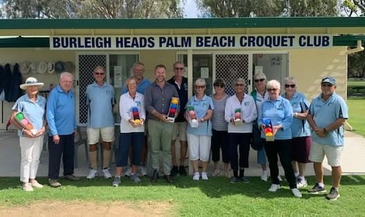 Councillor Josh Martin presents new balls to Burleigh Heads Palm Beach