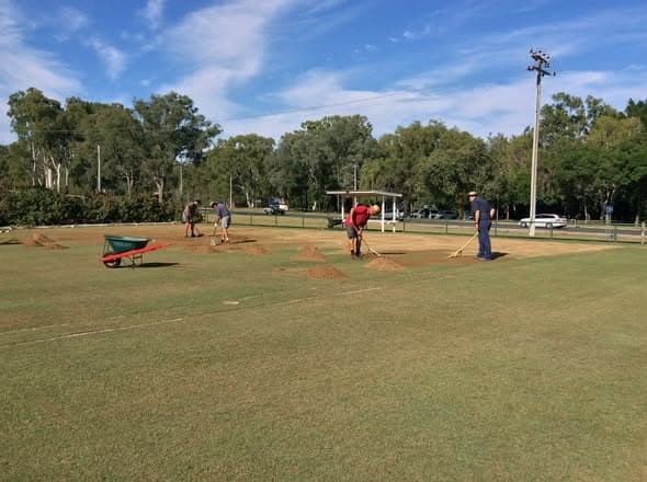 Gladstone members out early to top dress courts