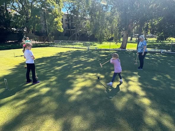 Gayle Petrie passes on croquet skills to grandchildren