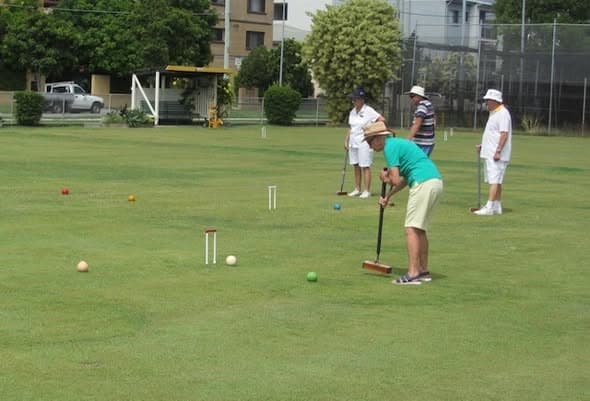 Toombul marks Australia Day with flag raising and croquet, then scarifies lawns